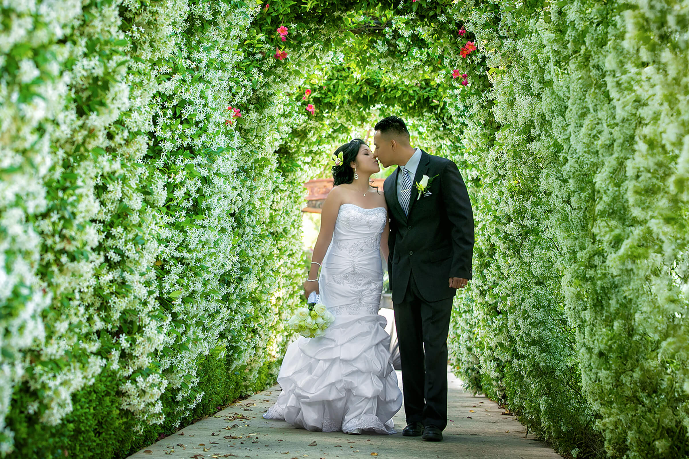 Wedding Videography Los Angeles - Garden floral arch wedding kiss by IMAGE369